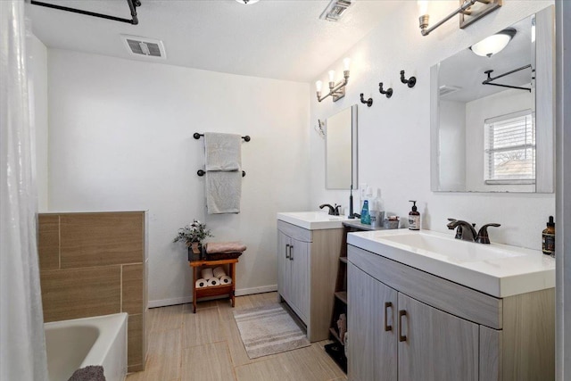 bathroom featuring vanity, a bathtub, and hardwood / wood-style flooring