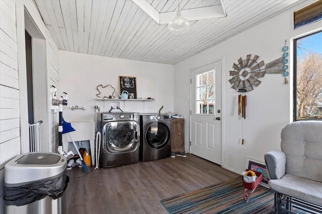 laundry area with hardwood / wood-style flooring, washing machine and dryer, and wooden ceiling