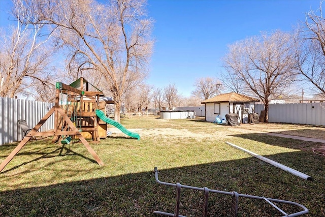 view of play area featuring an outbuilding and a lawn