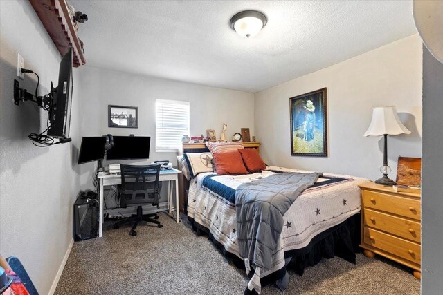 bedroom with carpet flooring and a textured ceiling