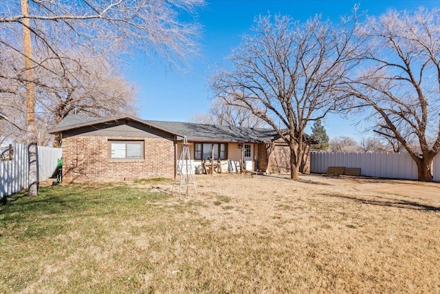 back of house featuring a yard