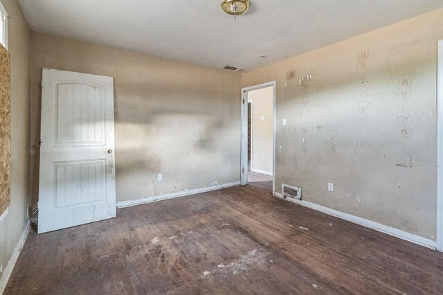 unfurnished room featuring dark hardwood / wood-style flooring