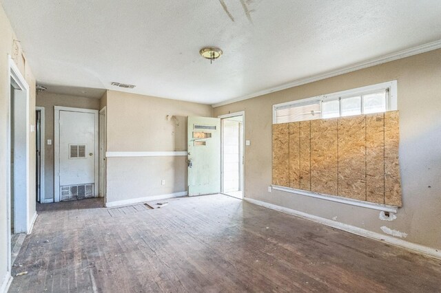 spare room with hardwood / wood-style flooring and a textured ceiling