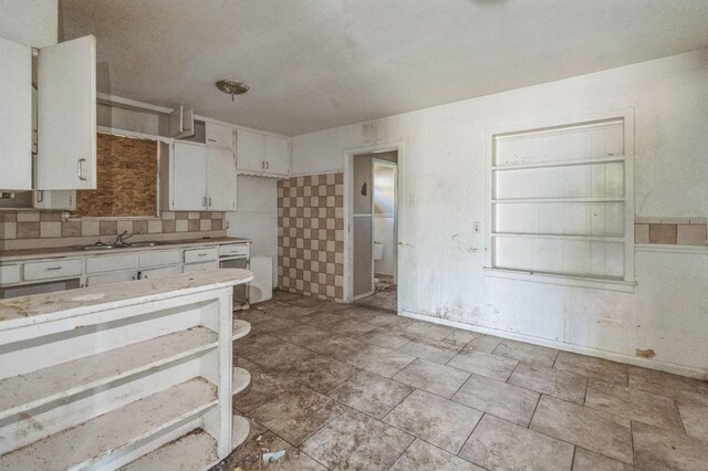 kitchen with sink, decorative backsplash, and white cabinets