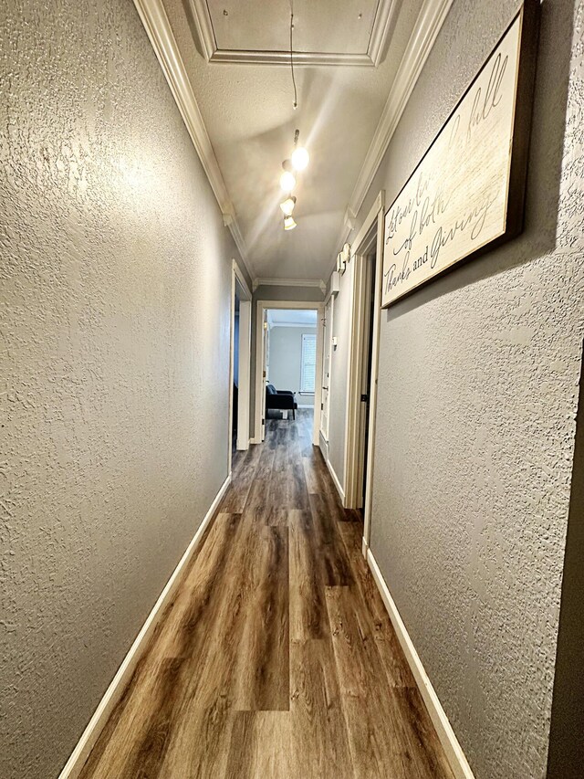5712 70th Pl, Lubbock, TX 79424 - hall featuring attic access, ornamental molding, wood finished floors, and a textured wall
