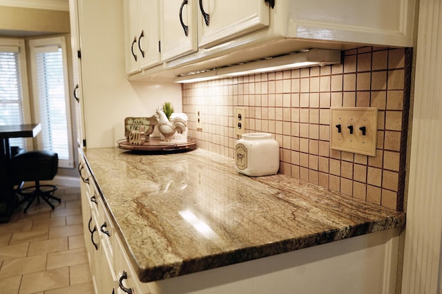 5712 70th Pl, Lubbock, TX 79424 - kitchen with white cabinets, decorative backsplash, and light stone countertops