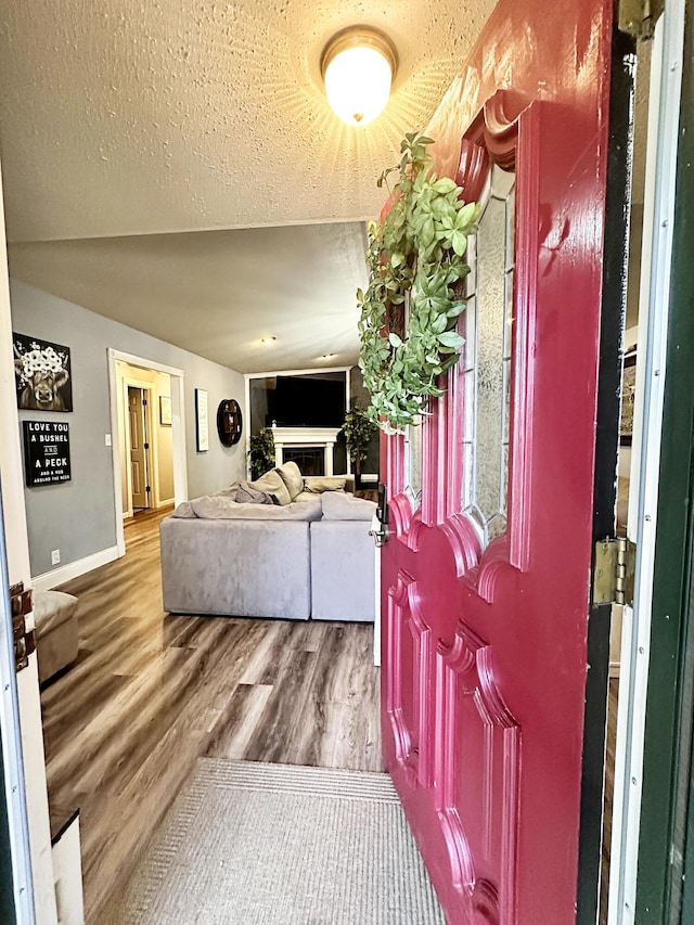 5712 70th Pl, Lubbock, TX 79424 - entryway with a fireplace, wood finished floors, and a textured ceiling