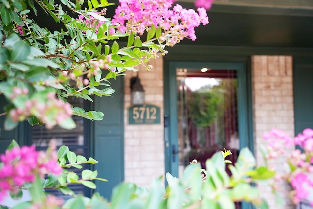 5712 70th Pl, Lubbock, TX 79424 - property entrance featuring brick siding and a porch
