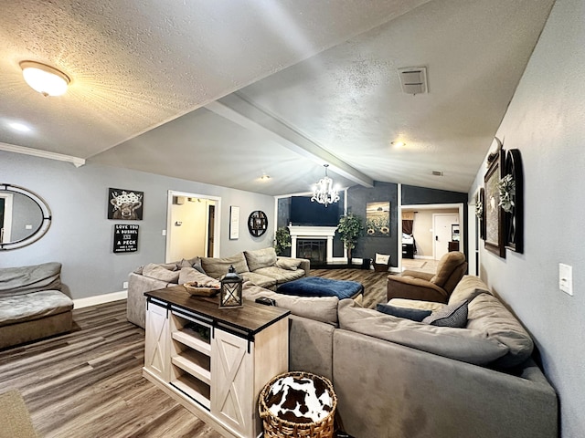 5712 70th Pl, Lubbock, TX 79424 - living room with dark wood finished floors, vaulted ceiling, a textured ceiling, a chandelier, and a glass covered fireplace