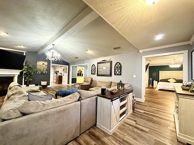 5712 70th Pl, Lubbock, TX 79424 - living area with light wood-style floors, a chandelier, a fireplace, a textured ceiling, and ornamental molding
