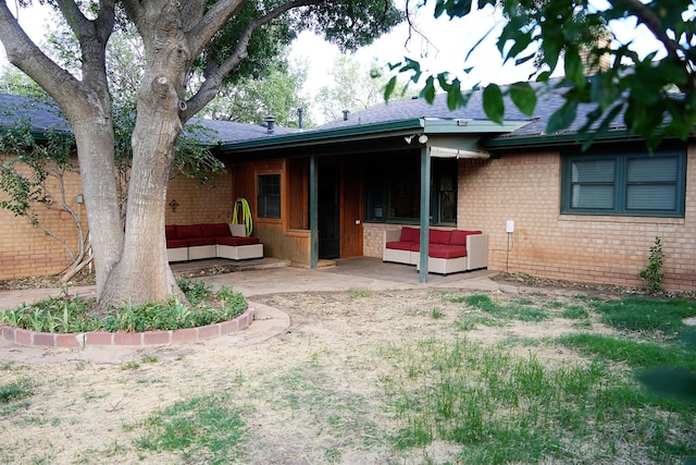 5712 70th Pl, Lubbock, TX 79424 - rear view of house featuring outdoor lounge area, a patio area, brick siding, and roof with shingles