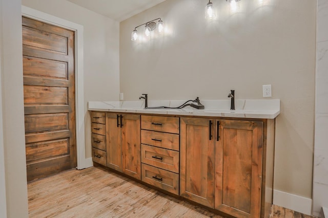 bathroom featuring hardwood / wood-style flooring and vanity