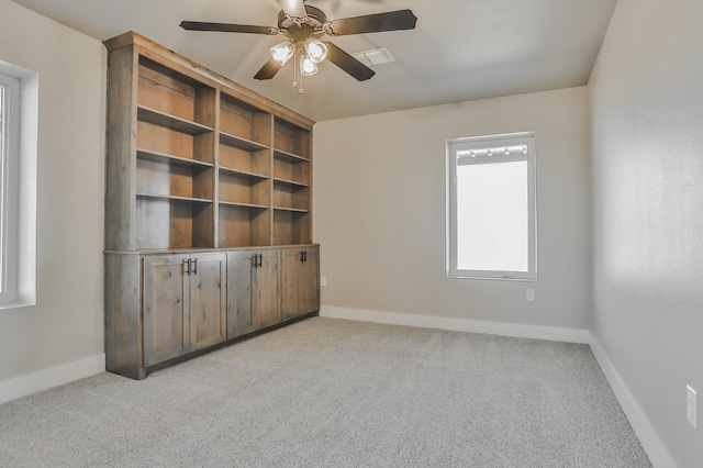 unfurnished room with ceiling fan and light colored carpet