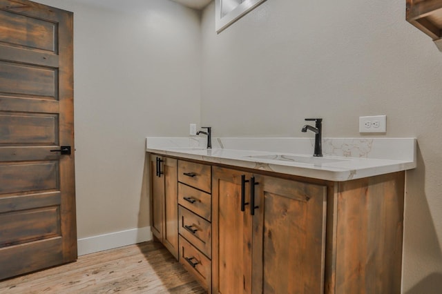 bathroom with vanity and wood-type flooring