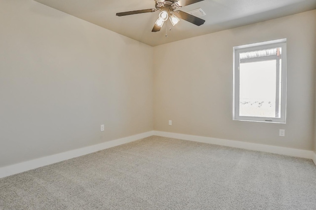 empty room with ceiling fan and carpet