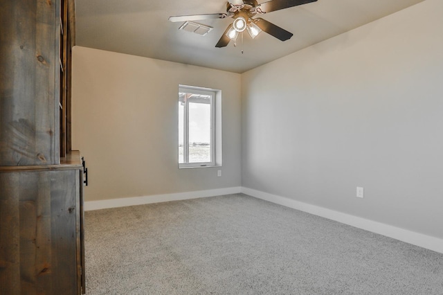 unfurnished room with light colored carpet and ceiling fan