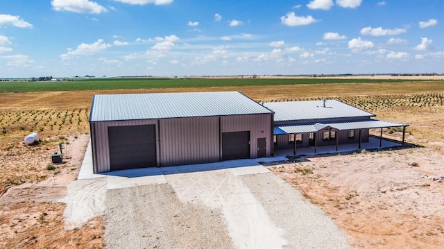 view of front of house with a rural view and a garage