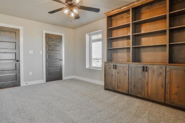 unfurnished bedroom featuring light carpet and ceiling fan