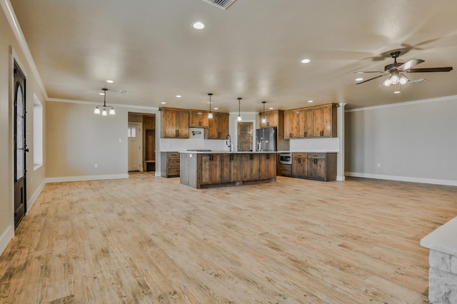 kitchen with decorative light fixtures, tasteful backsplash, a center island, stainless steel refrigerator with ice dispenser, and light hardwood / wood-style flooring