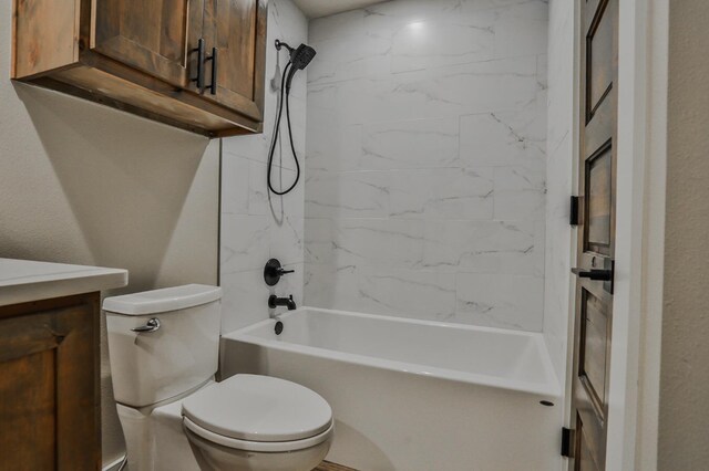 full bathroom featuring vanity, tiled shower / bath combo, and toilet