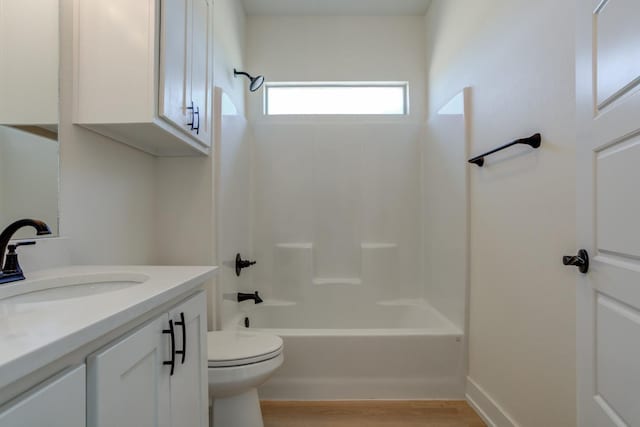 full bathroom featuring hardwood / wood-style flooring, vanity, toilet, and bathing tub / shower combination