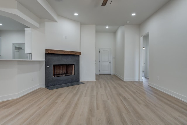 unfurnished living room with ceiling fan and light wood-type flooring