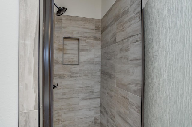 interior space with tiled shower