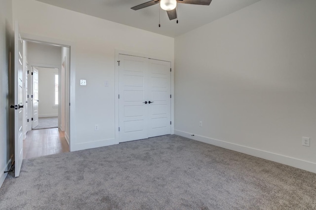 unfurnished bedroom featuring light carpet and ceiling fan