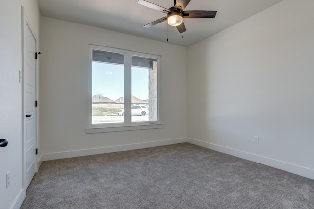 carpeted spare room with ceiling fan