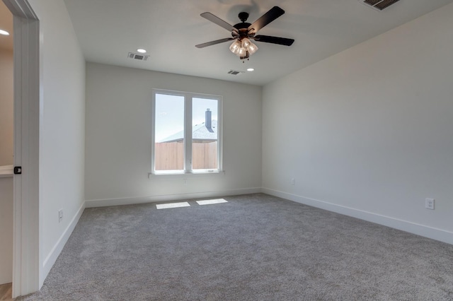 empty room with light colored carpet and ceiling fan