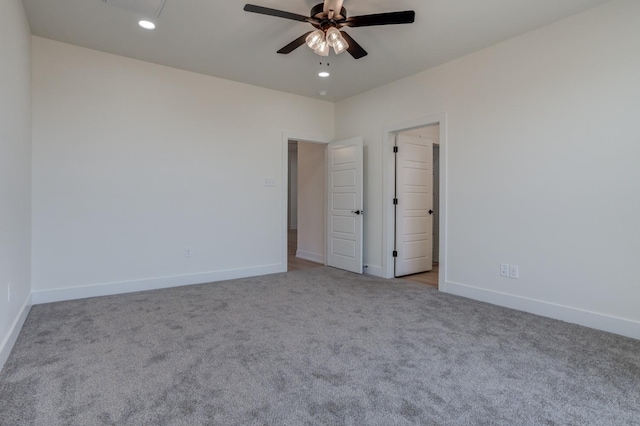 empty room with ceiling fan and light carpet