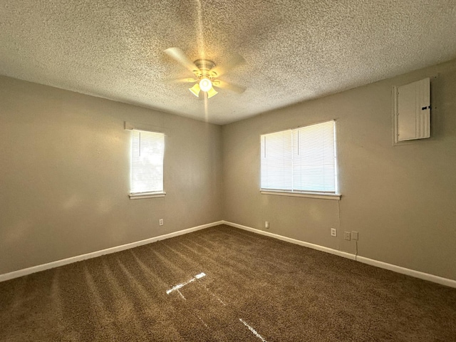 unfurnished room with carpet flooring, a textured ceiling, ceiling fan, and electric panel