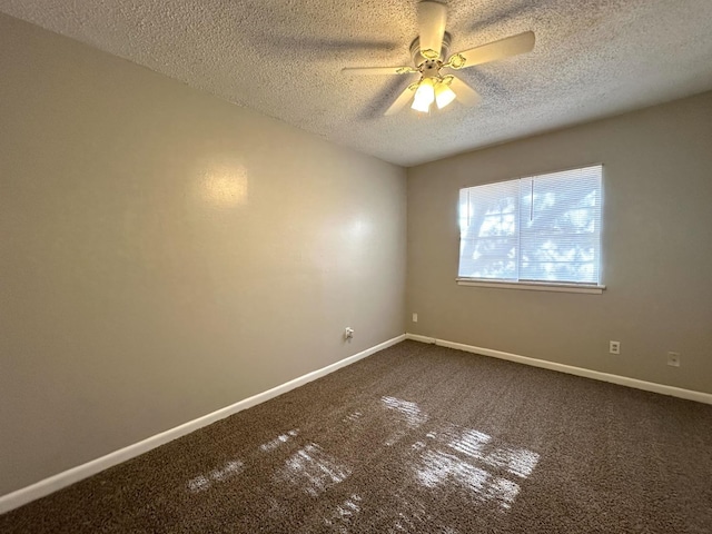 carpeted empty room with ceiling fan and a textured ceiling