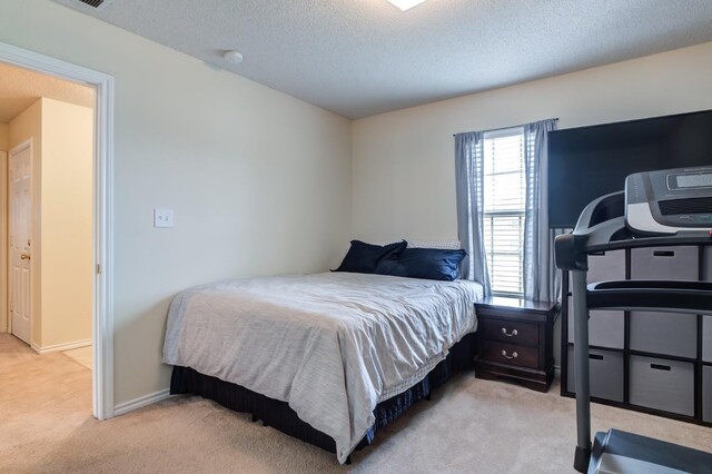 carpeted bedroom featuring a textured ceiling