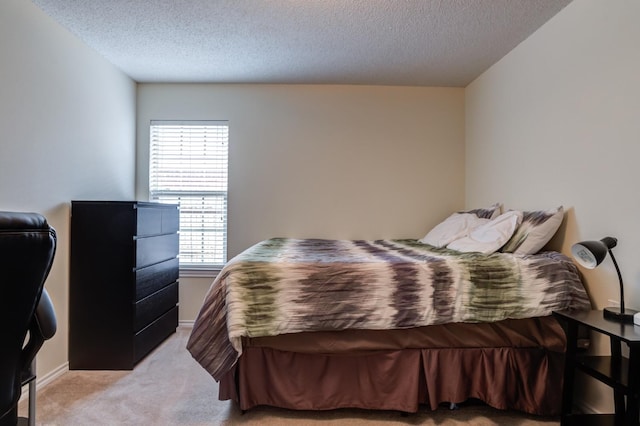 carpeted bedroom featuring a textured ceiling