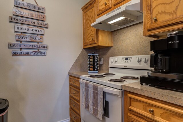 kitchen featuring white electric range oven and decorative backsplash