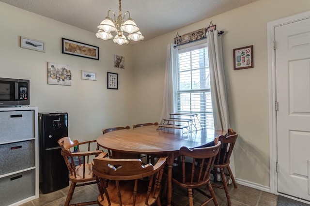 dining space featuring an inviting chandelier and tile patterned floors