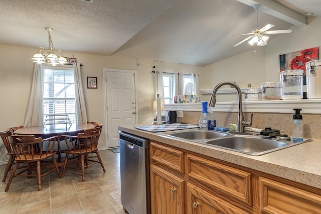 kitchen with decorative light fixtures, lofted ceiling with beams, sink, stainless steel dishwasher, and a textured ceiling