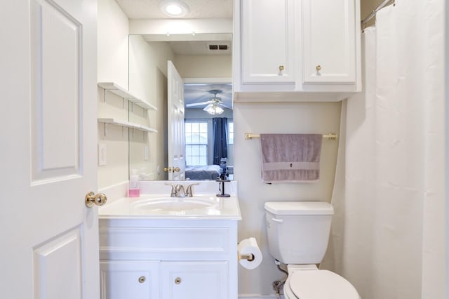 bathroom with vanity, ceiling fan, and toilet