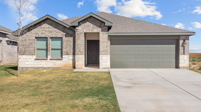 view of front of house featuring a garage and a front lawn