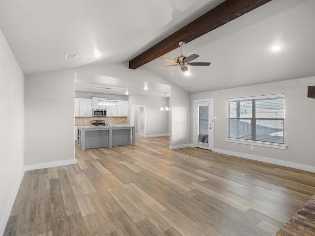 unfurnished living room with vaulted ceiling with beams, light hardwood / wood-style flooring, and ceiling fan