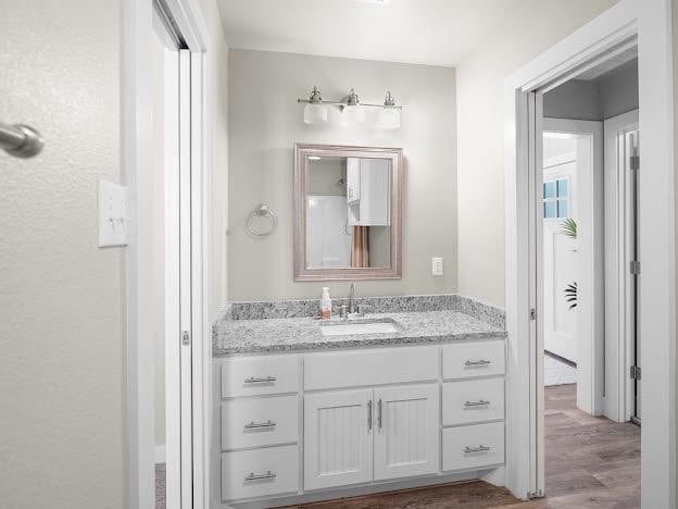 bathroom with vanity and hardwood / wood-style floors