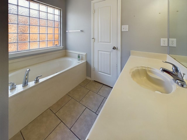 bathroom with tile patterned flooring, vanity, and a tub to relax in