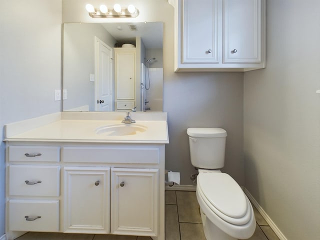 bathroom with vanity, a shower, tile patterned floors, and toilet