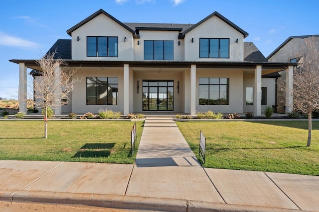 modern farmhouse style home with stucco siding, a shingled roof, and a front yard