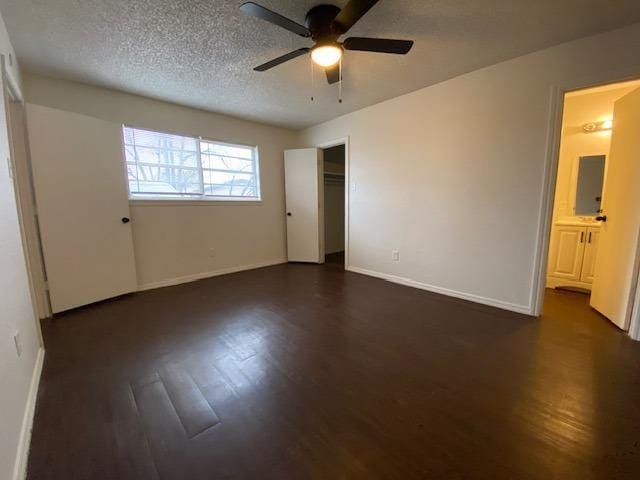 unfurnished bedroom featuring ceiling fan, dark hardwood / wood-style flooring, a closet, and a textured ceiling