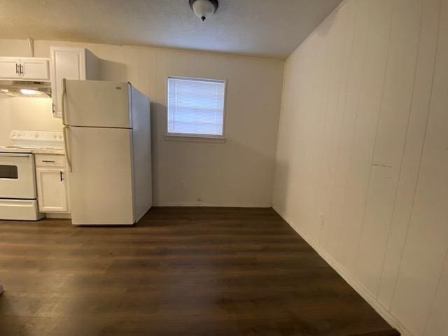 kitchen with white cabinetry, dark hardwood / wood-style floors, and white appliances