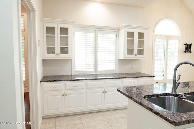 4420 87th St, Lubbock, TX 79424 - kitchen featuring a sink, glass insert cabinets, white cabinetry, and light tile patterned floors