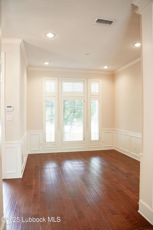 4420 87th St, Lubbock, TX 79424 - empty room featuring a decorative wall, wainscoting, dark wood-style flooring, ornamental molding, and recessed lighting