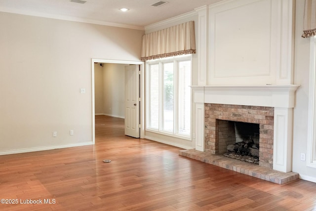 4420 87th St, Lubbock, TX 79424 - unfurnished living room featuring a fireplace, baseboards, light wood finished floors, crown molding, and recessed lighting